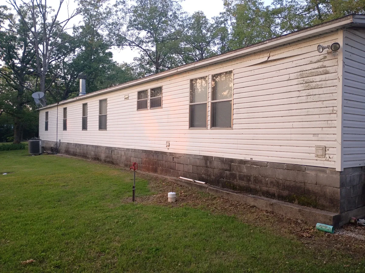 long house wall stained and discolored before washing