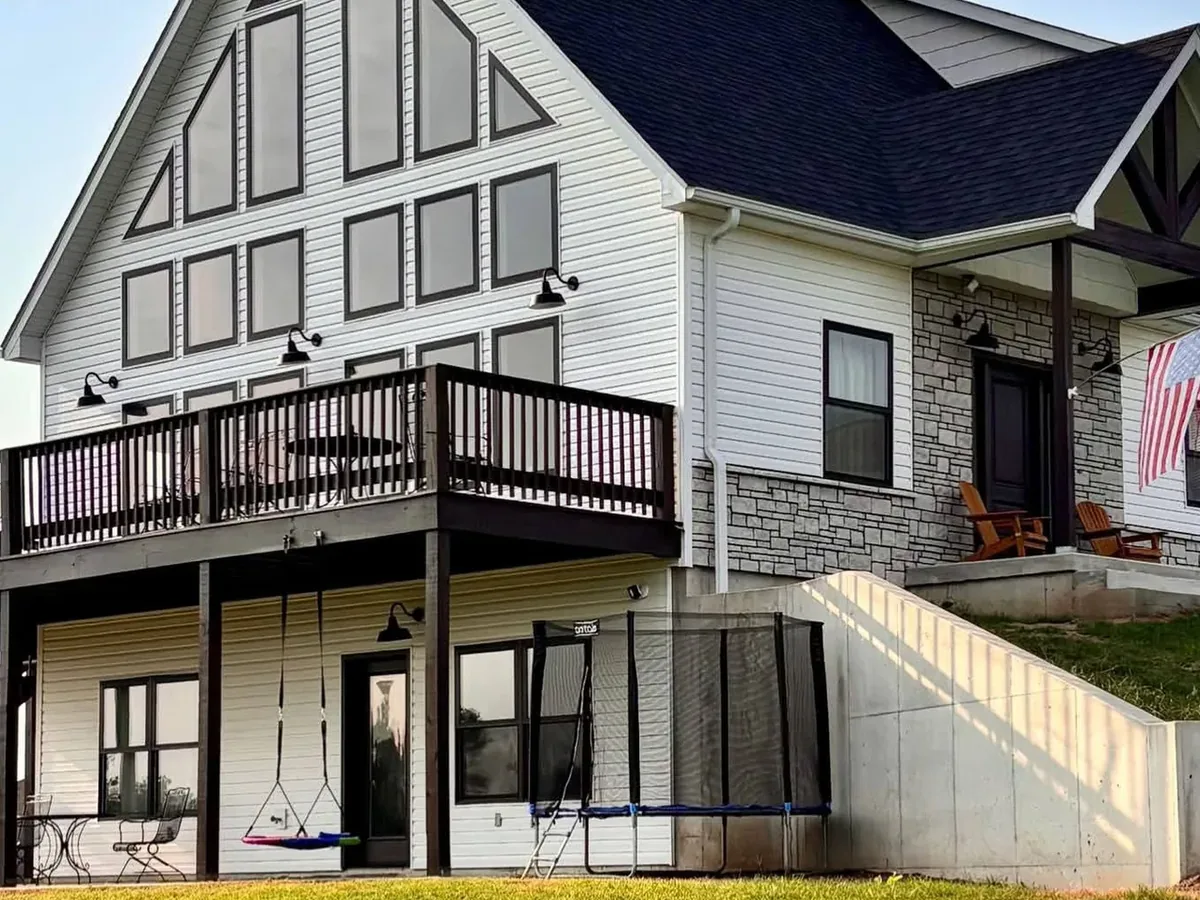 finished home with dark stained deck and railings