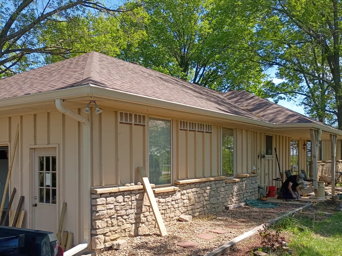 rear of ranch home mid project with bare ground
