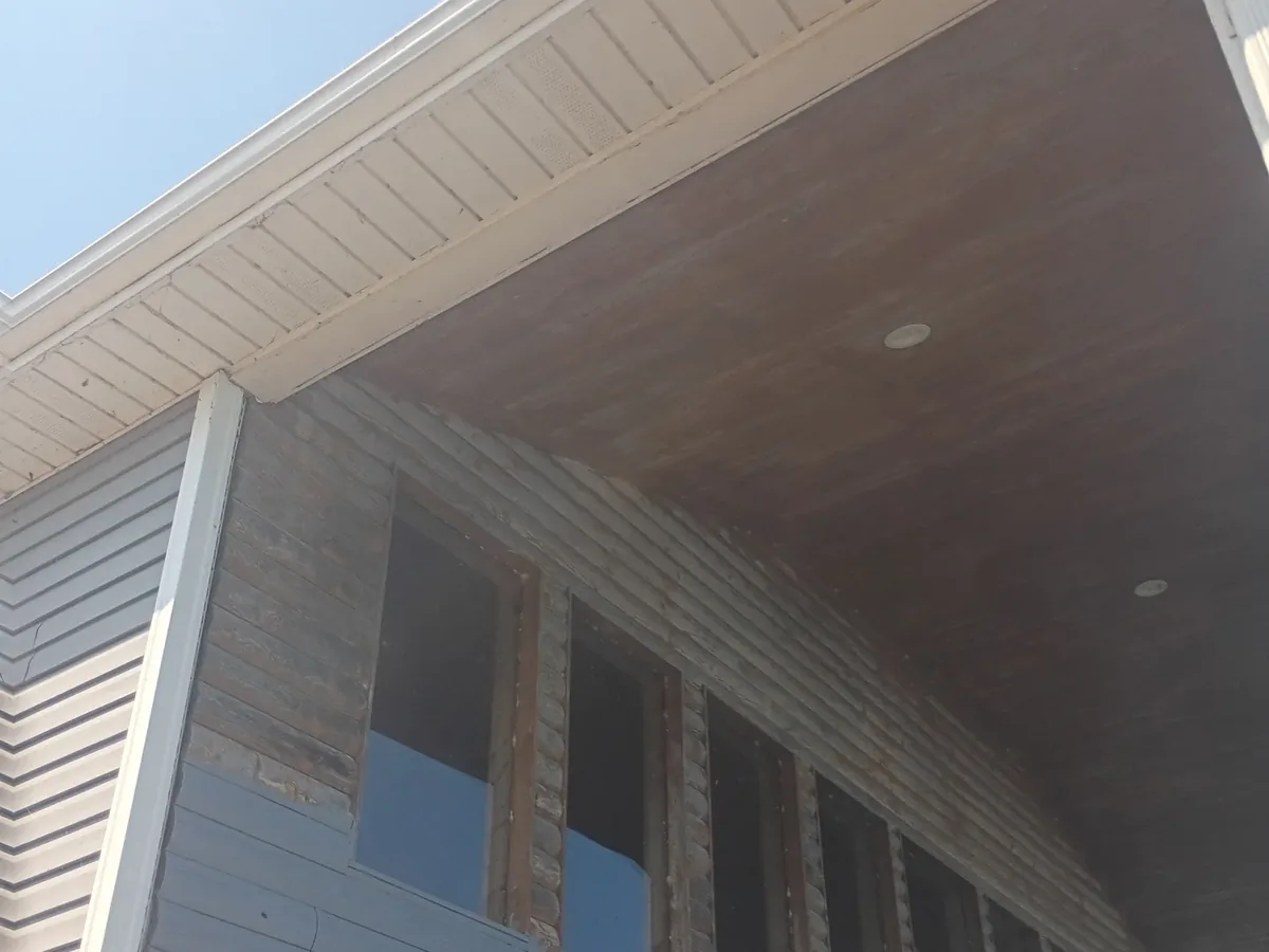 unfinished soffit and exposed framing under porch