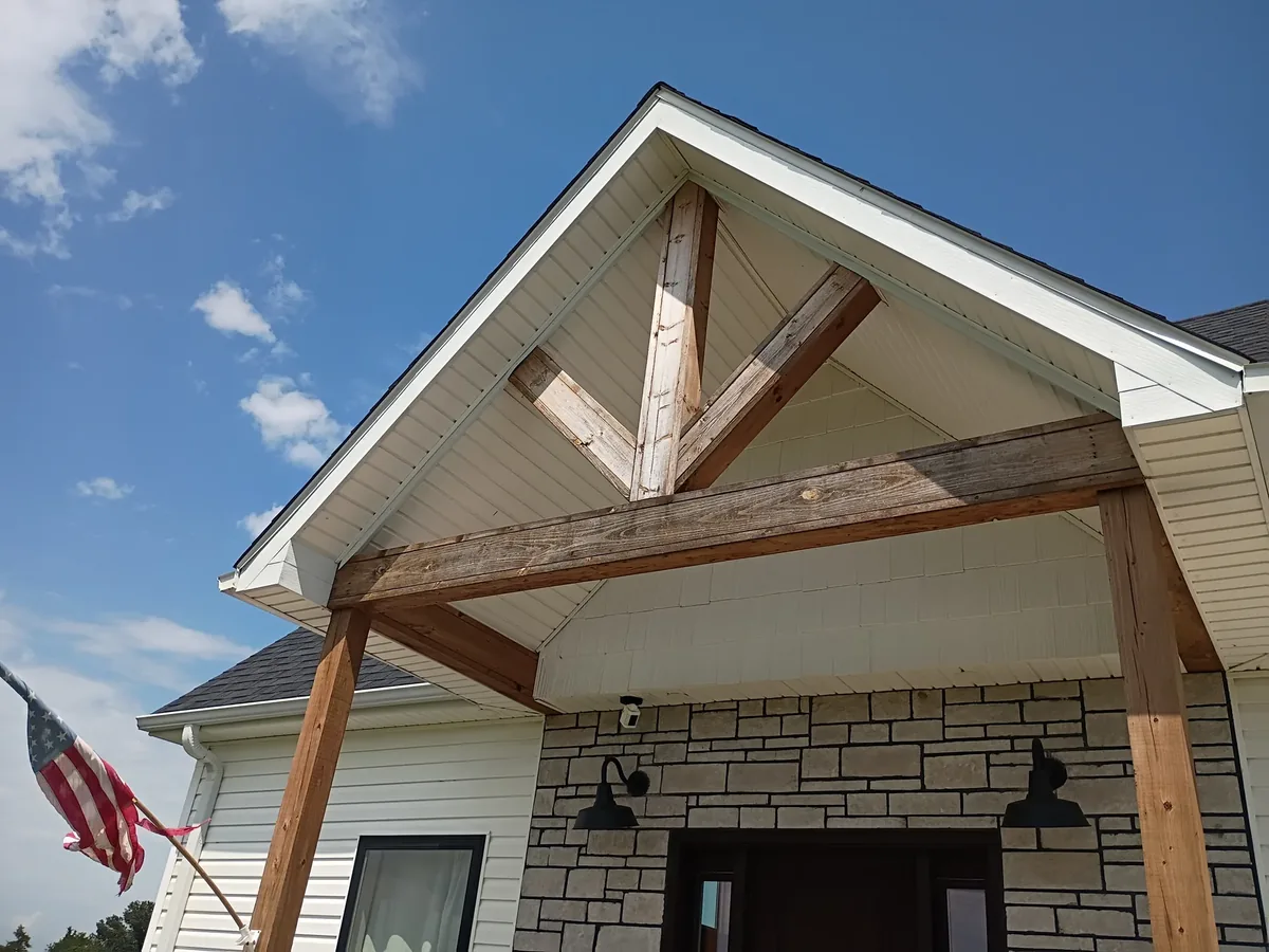 covered entry with raw unfinished cedar timbers