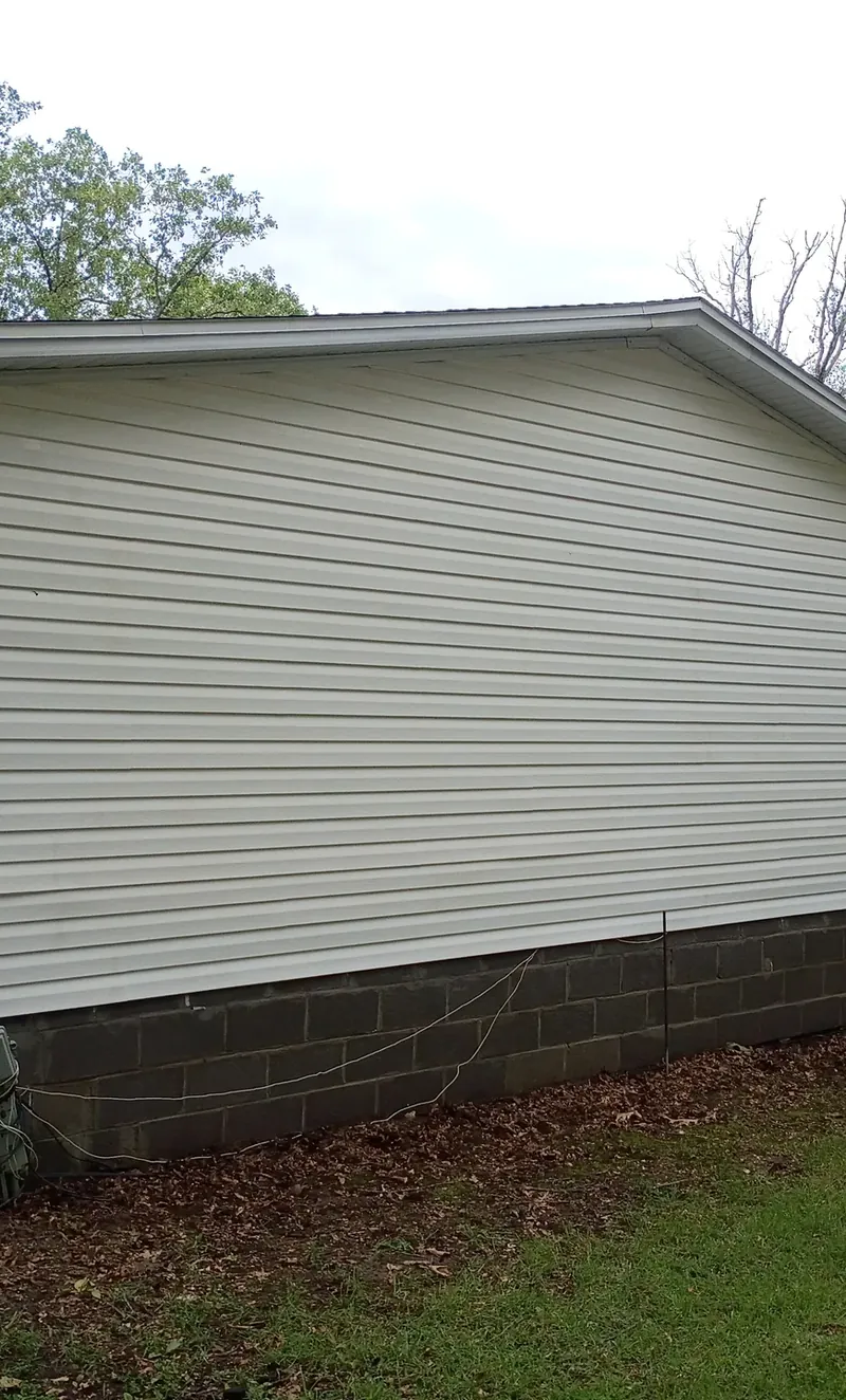 clean white siding on a lake house after soft washing